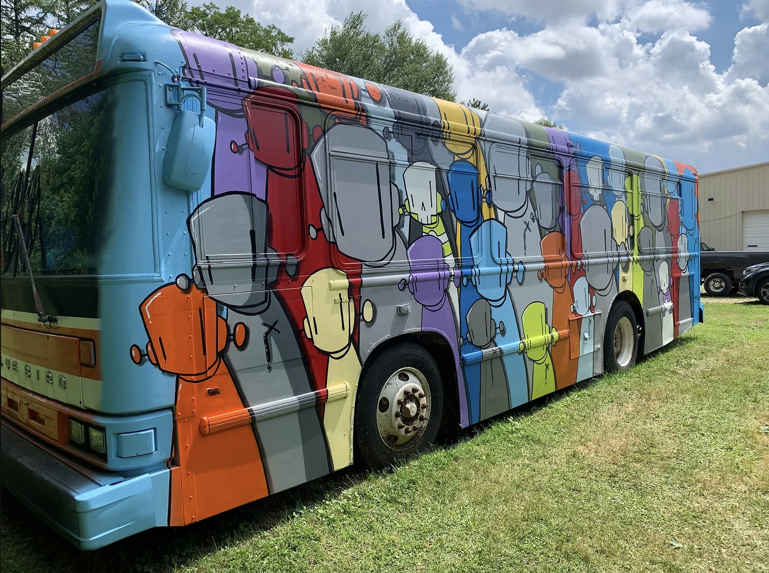Chris RWK painting of a city bus decorated with robot characters